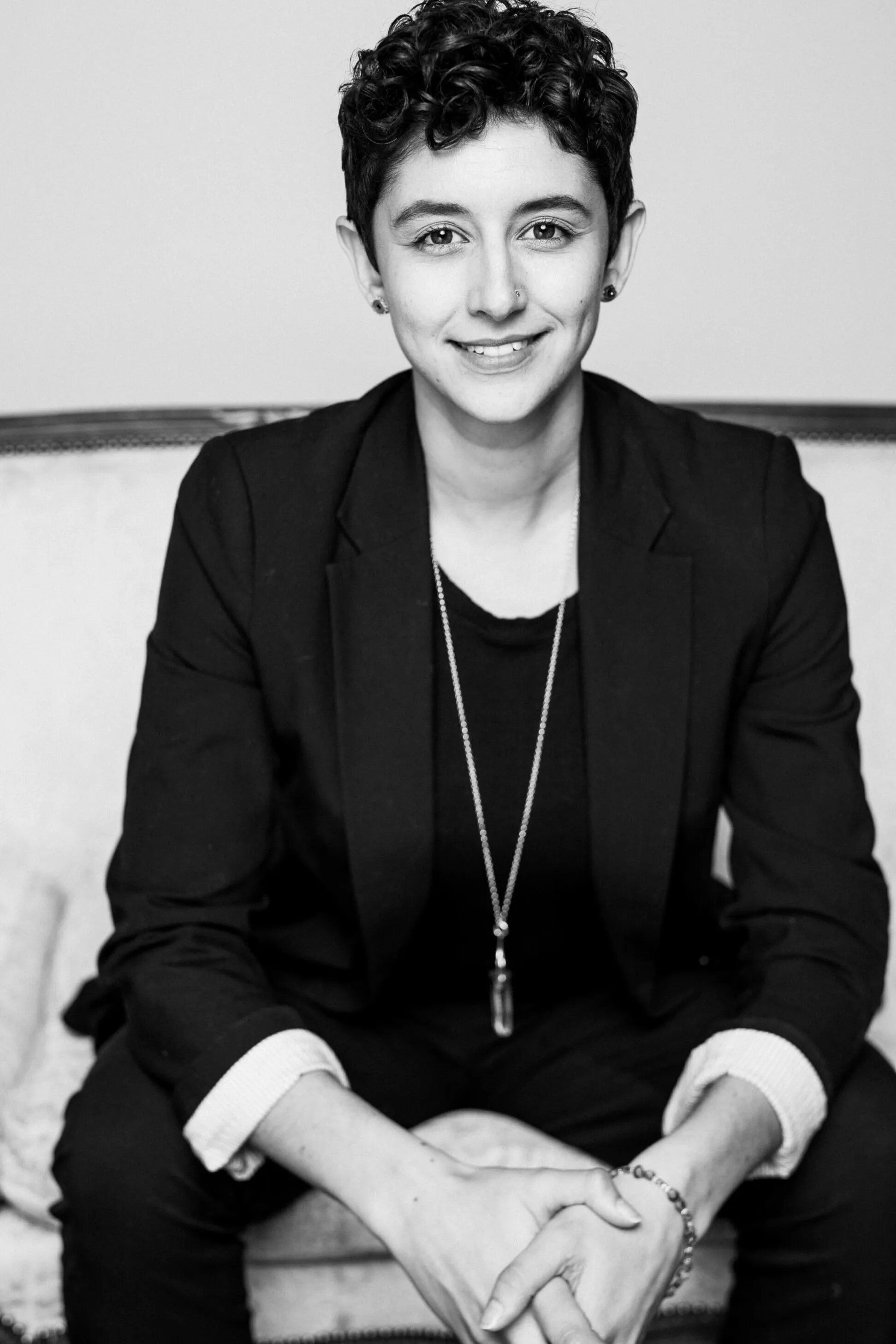 Gillian Cofsky, smiling, seated with hands clasped